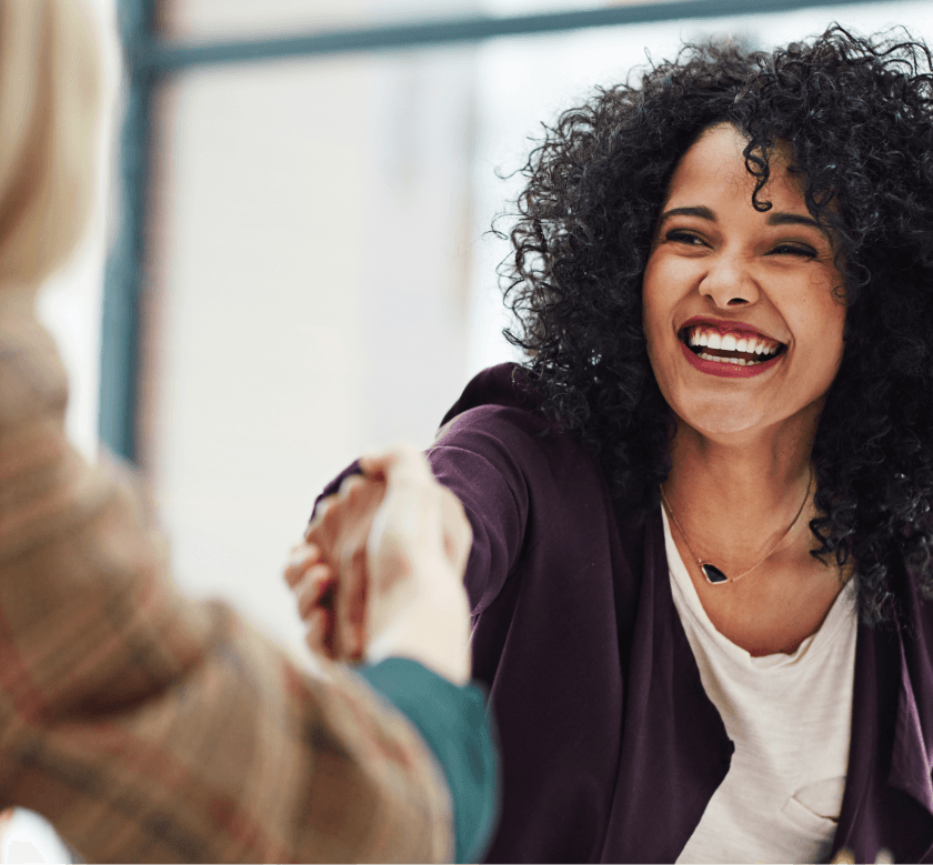 A woman smiling confidently, representing recruitment tools for care providers