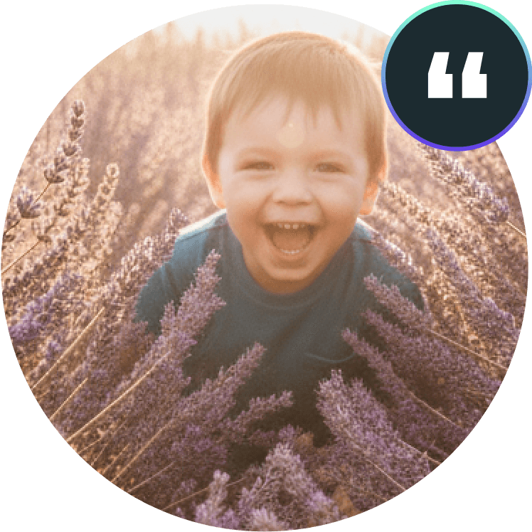 support_for_learning_disabilities_testimonial — A joyful young child with a big smile laughing in a field of purple flowers, representing a support for learning disabilities testimonial
