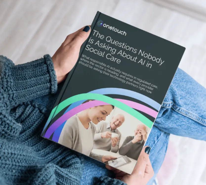 A person holds a OneTouch guidebook with the title "The Questions Nobody is Asking About AI in Social Care"